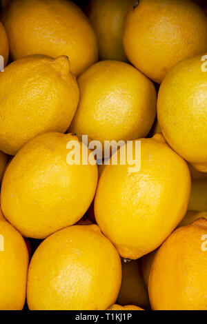 Heap of yellow ripe lemon fruits close-up top view Stock Photo