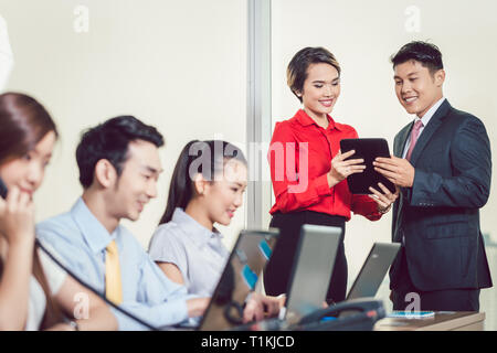Business partners having discussion using digital tablet Stock Photo