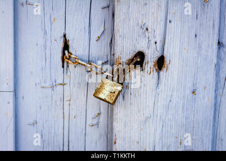 Old weathered wooden lilac door with a lock Stock Photo
