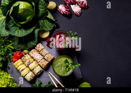 Japanese food. Healthy vegan drinks with fruits and vegetables on the black background. Flat lay Stock Photo