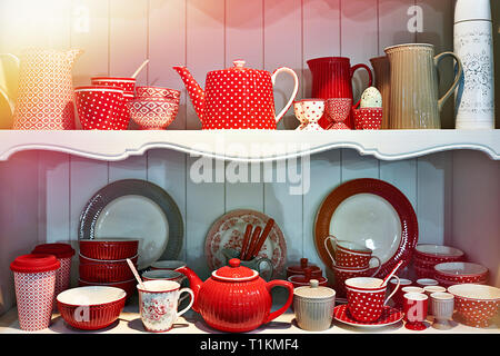 Red antique porcelain utensils in the sideboard Stock Photo