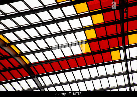 Roof with colored windows of red white and yellow generates a geometric texture Stock Photo