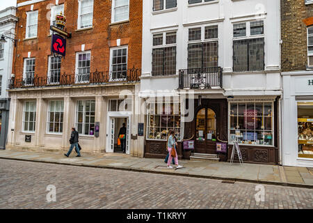 Guildford, United Kingdom - March 23, 2019: people walking by the tourist information and house gallery in the city centre high street of the medieval Stock Photo