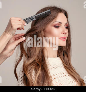 Elegant woman with makeup preparing for shooting in studio. Stock Photo