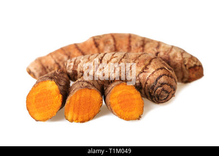 Turmeric roots whole and slices on white Stock Photo