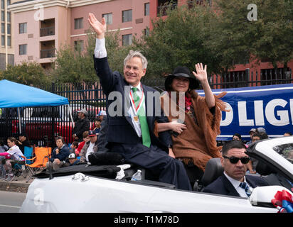Texas Gov. Greg Abbott and his wife, Cecilia, wave to crowd during annual Washington's Birthday Celebration parade in downtown Laredo. Stock Photo