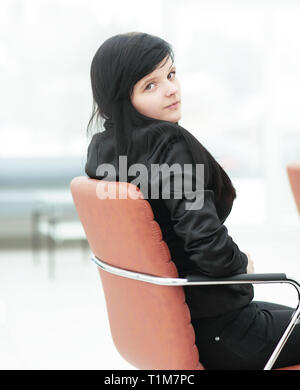 side view.young business woman sitting in office chair Stock Photo