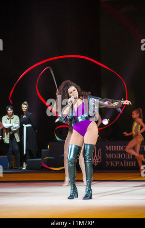 KYIV, UKRAINE - MARCH 17, 2019:  NK (Nastya Kamenskykh) performs with gymnasts at gala concert of Deriugina Cup Grand Prix (Rhythmic Gymnastics) Stock Photo