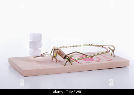 Sugar cubes on mousetrap Stock Photo