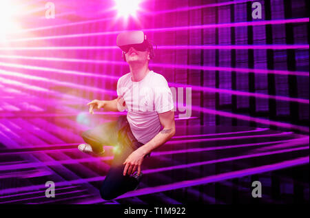 Young man using virtual reality simulator glasses Stock Photo