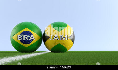 Brazil vs. Jamaica Soccer Match - Soccer balls in Brazils and Jamaicas national colors on a soccer field. Copy space on the right side - 3D Rendering Stock Photo