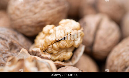 Walnut kernels and whole walnuts Stock Photo