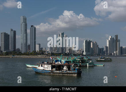 old fishing boats near fish market in Panama City with skyline background