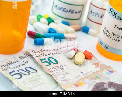 Medicines next to banknotes of Venezuela, shady deal of medication in full crisis of country of Latin America, conceptual image Stock Photo