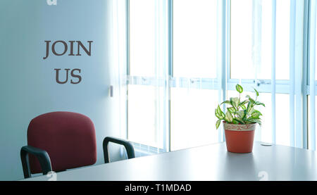 Job recruitment or hiring concept, office room scene with words Join Us Stock Photo