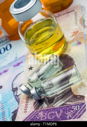 Vials with medication on banknotes Bolivarian, shady deal of medicines in full crisis of Latin American country, conceptual image Stock Photo