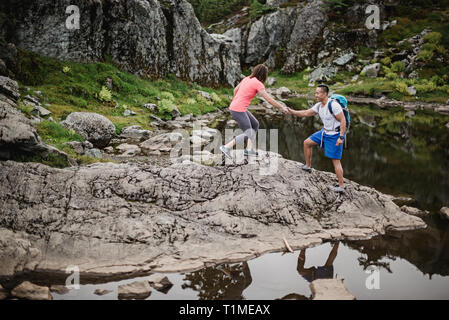 Couple hiking on rocks, Dog Mountain, BC, Canada Stock Photo