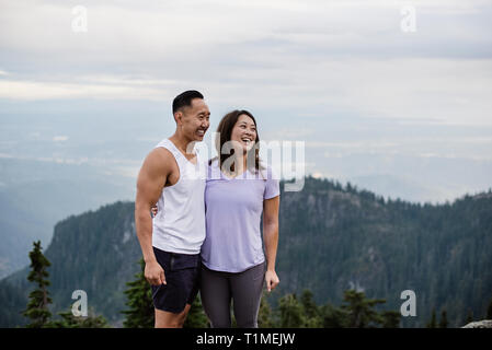 Happy couple hiking on mountaintop Stock Photo