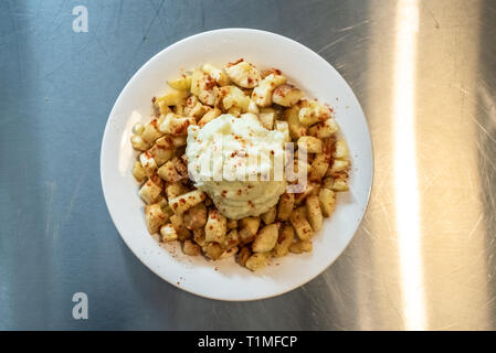 Yuca fried with hummus sauce. Stock Photo