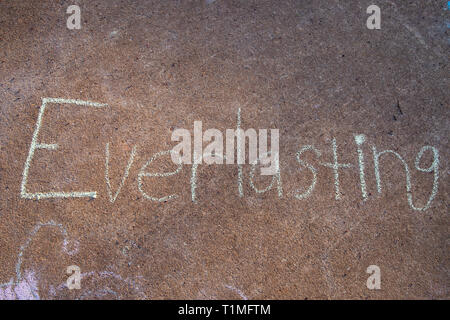 the word Everlasting written with sidewalk chalk on gray concrete pavement background Stock Photo