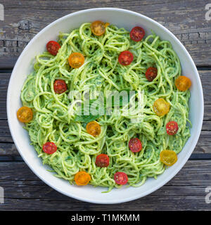 Zucchini noodle pesto pasta with grape tomatoes Stock Photo