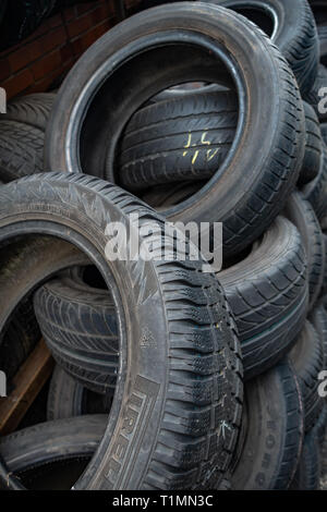 Random pile of used car tyres piled up for resale in a distribution centre Stock Photo