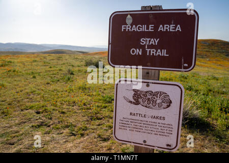 Lancaster, California - March 24, 2019: Sign warns tourists at the Antelope Valley Poppy Reserve to stay on the trail to preserve fragile wildflower a Stock Photo