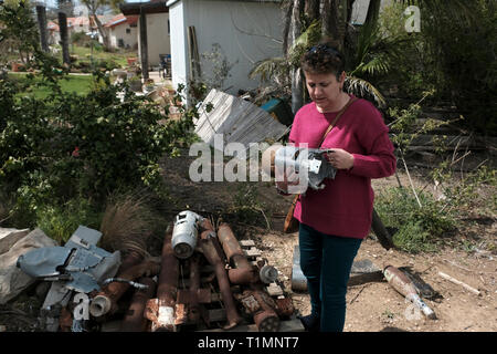 Esther Marcus resident of Kibbutz Alumim holds remnants of exploded mortar shells that were fired from the Gaza Strip toward Kibbutz Alumim. Southern Israel Stock Photo