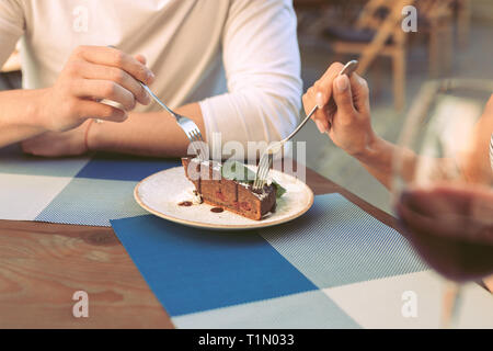Couple having romantic dinner and tasting chocolate dessert Stock Photo