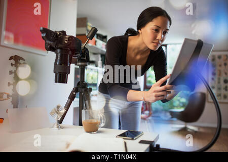 Female photographer working in studio, using digital tablet Stock Photo