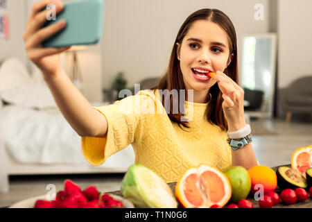 Woman making a selfie while eating healthy food Stock Photo