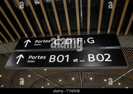 Gates (portes) and arrows signs inside Terminal 1 at Lyon's Saint Exupery International Airport, France. Directional information inside airport termin