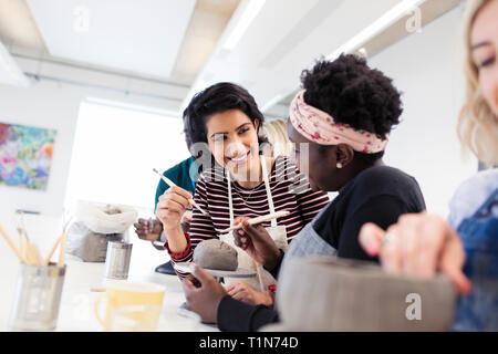 Women shaping clay in art class Stock Photo
