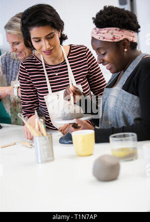 Women shaping clay in art class Stock Photo