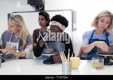Women shaping clay in art class Stock Photo