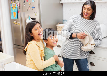 Portrait happy mother and children in kitchen Stock Photo