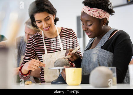 Women molding clay in art class Stock Photo