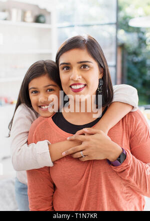 Portrait happy mother and daughter hugging Stock Photo