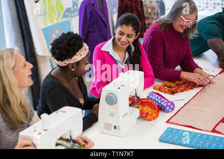 Fashion designers using sewing machines Stock Photo