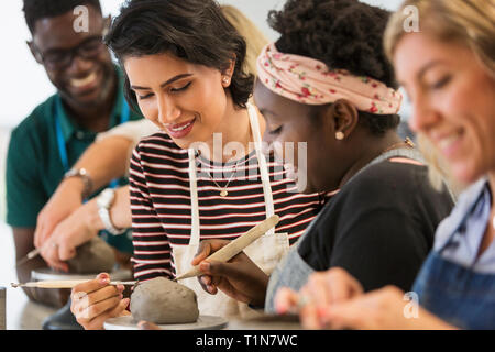 Women shaping clay in art class Stock Photo