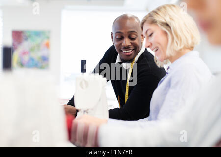Fashion designers using sewing machine Stock Photo
