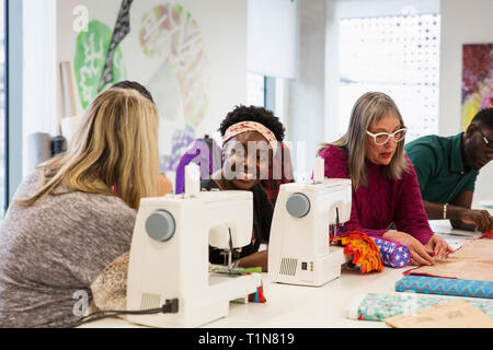 Female fashion designers working at sewing machines in studio Stock Photo