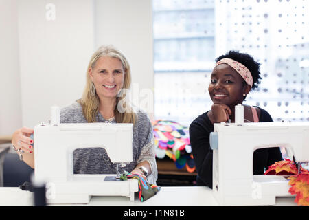 Portrait confident female fashion designers working at sewing machines Stock Photo