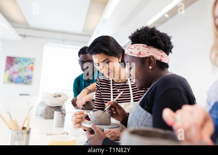 Woman shaping clay in art class Stock Photo