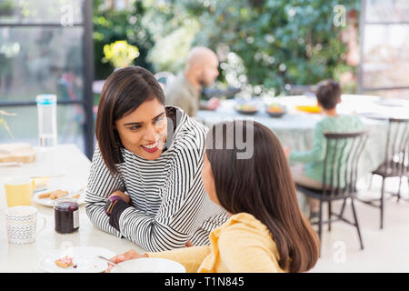 Mother and daughter talking, eating breakfast Stock Photo