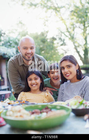 Portrait happy family at dinner table Stock Photo