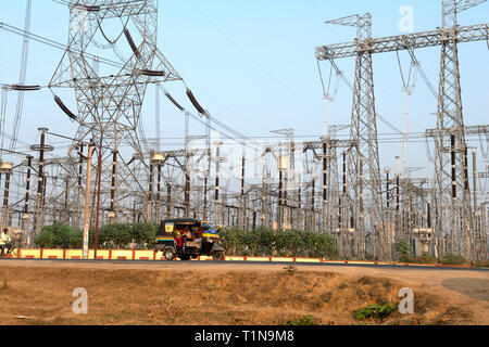 BODH GAYA, BIHAR, INDIA. November 27-2015. Tuk-Tuk Taxi passing a transformer station for a new high voltage line in rural India Stock Photo