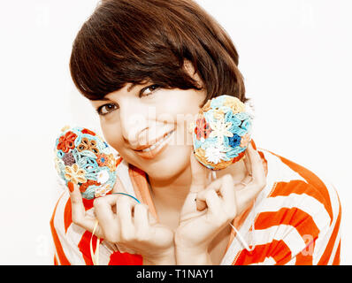 Joyful woman holding in the hands two colorful easter eggs made of colored paper. Teal and orange photo filter. Stock Photo