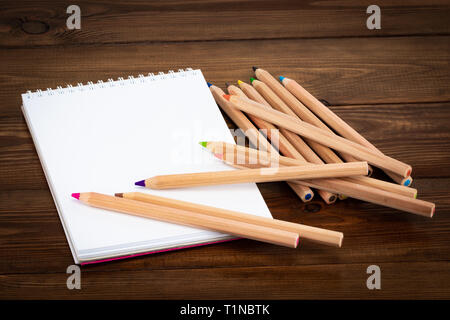 Blank notepad and pencil color on wooden blackground. Stock Photo