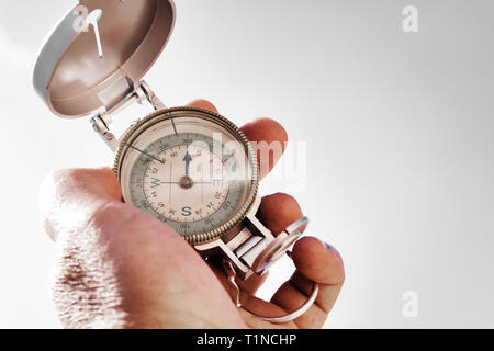 Close up hand holding a compass Stock Photo